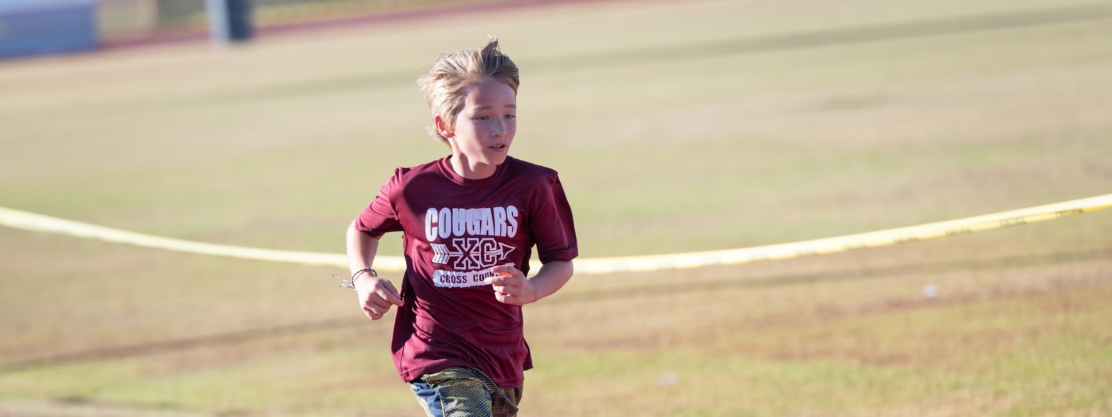Student running in cross country race.