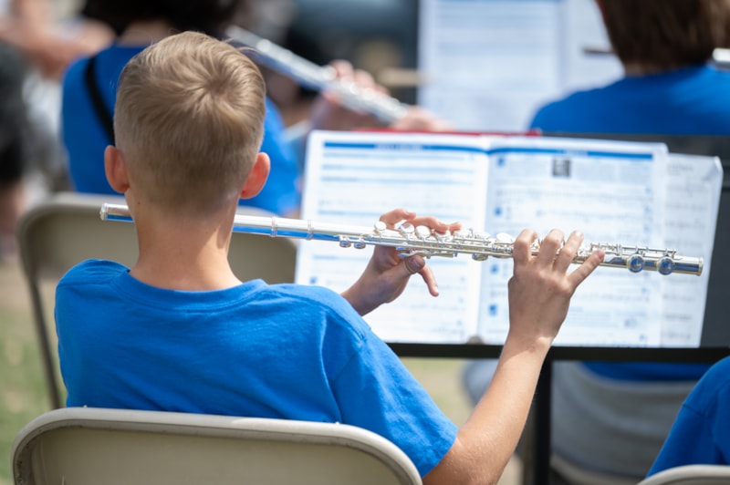 student playing instrument at a concert