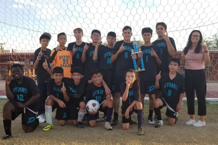 Soccer team from Dysart Middle School holding up championship trophy