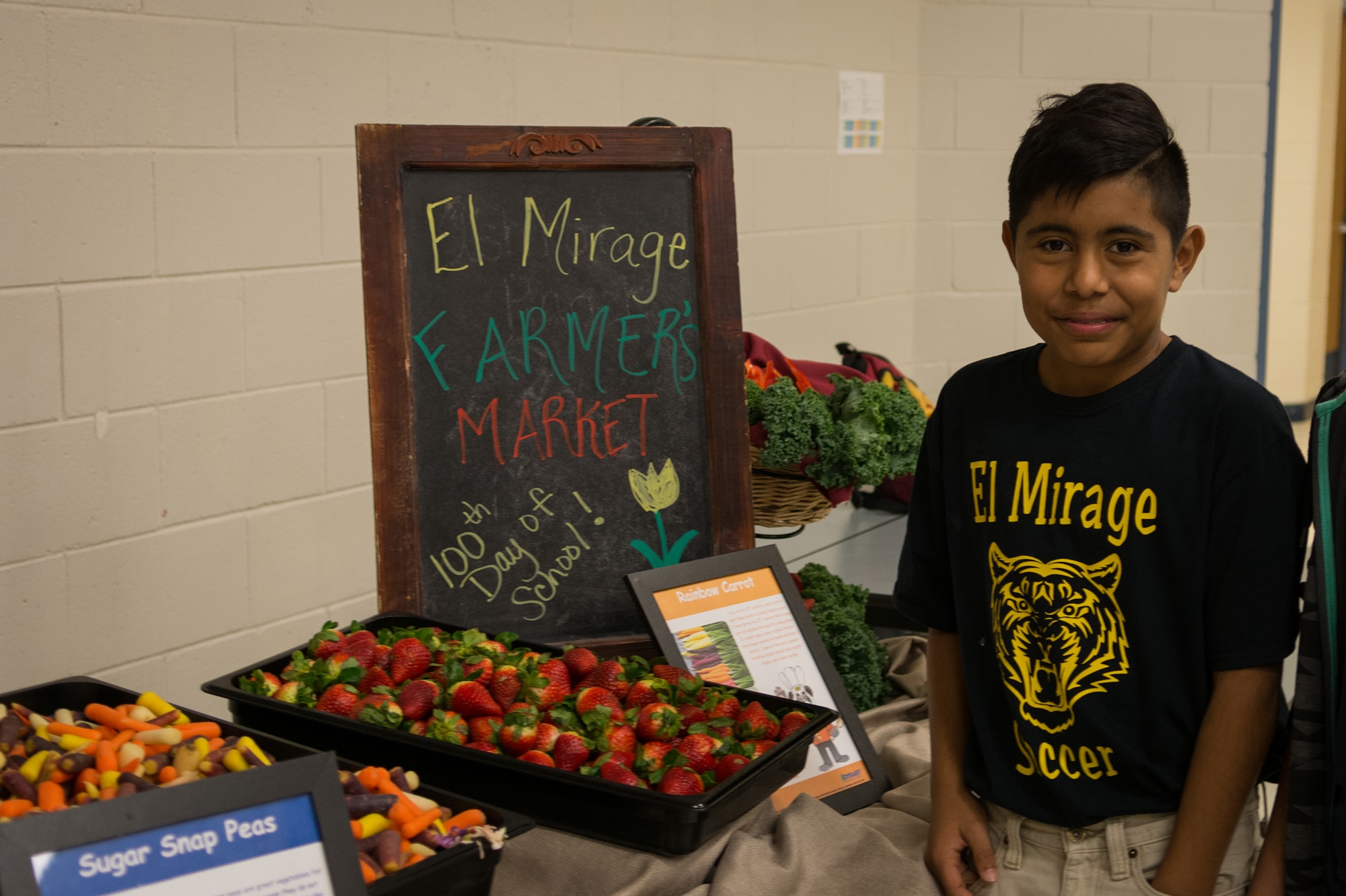 Student at farmer's market with fruits and vegetables