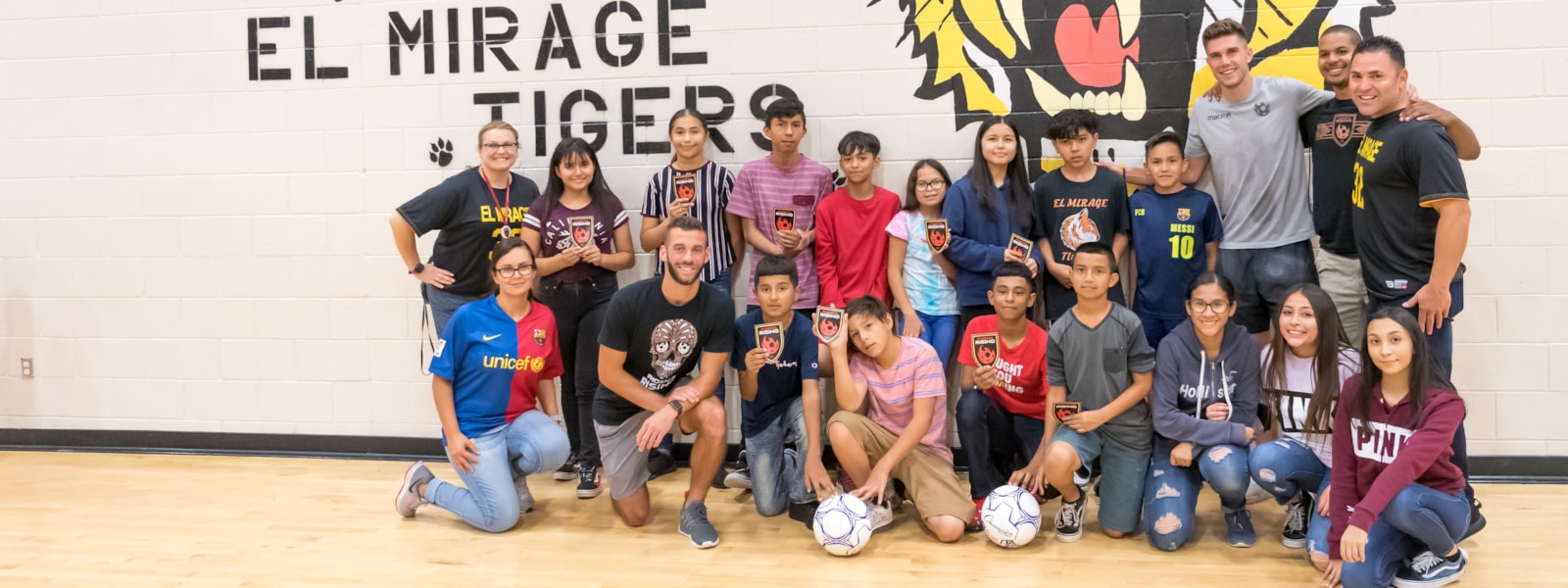 Phoenix Rising soccer players pose with El Mirage students.