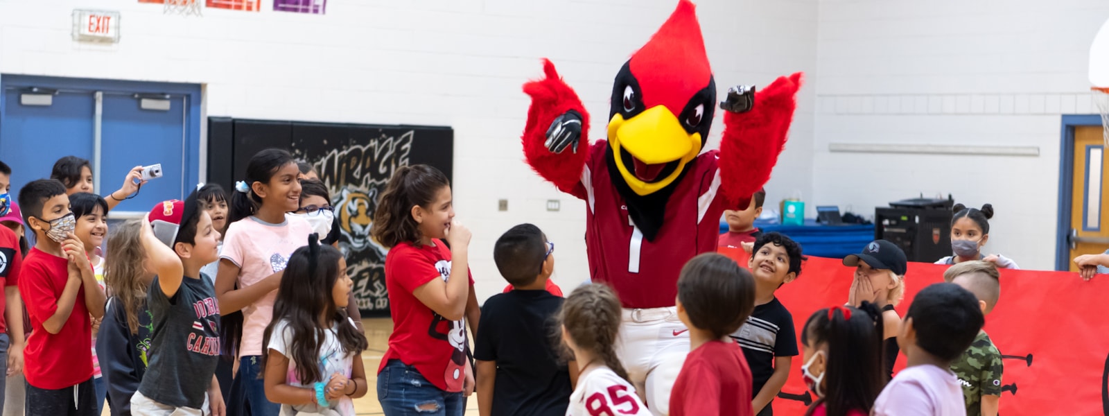 Big Red from the Arizona Cardinals speaks with children at El Mirage Elementary School.