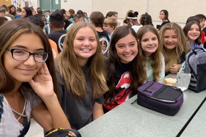 students smiling at lunch 