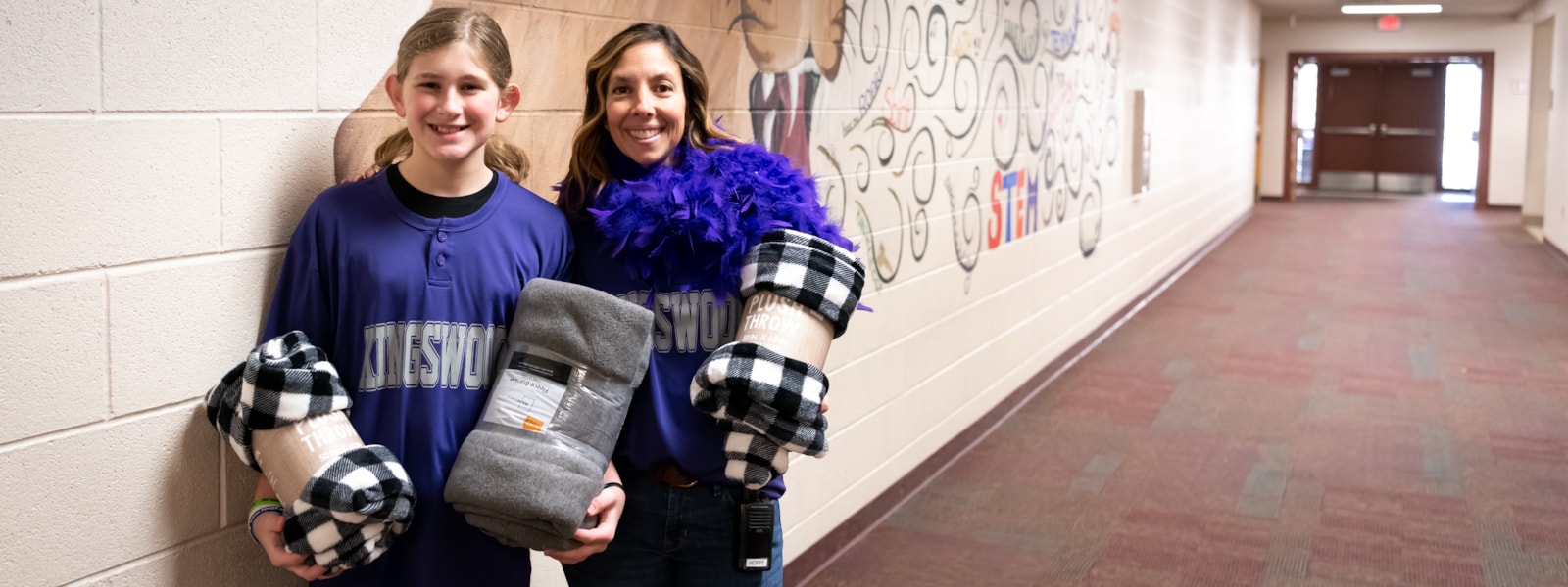 Canyon Ridge principal Jill Hoppe and Ollie McNeil pose for a photo with their buddy blankets.