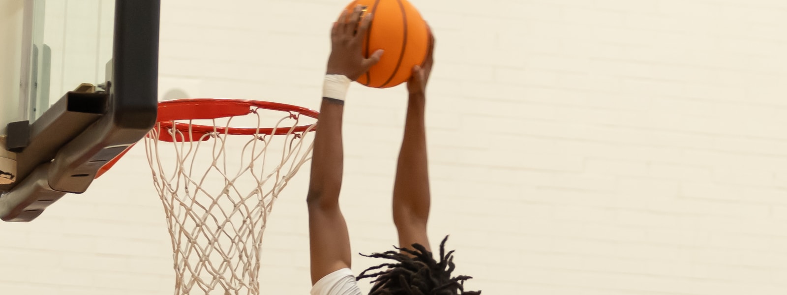 Basketball player dunking ball