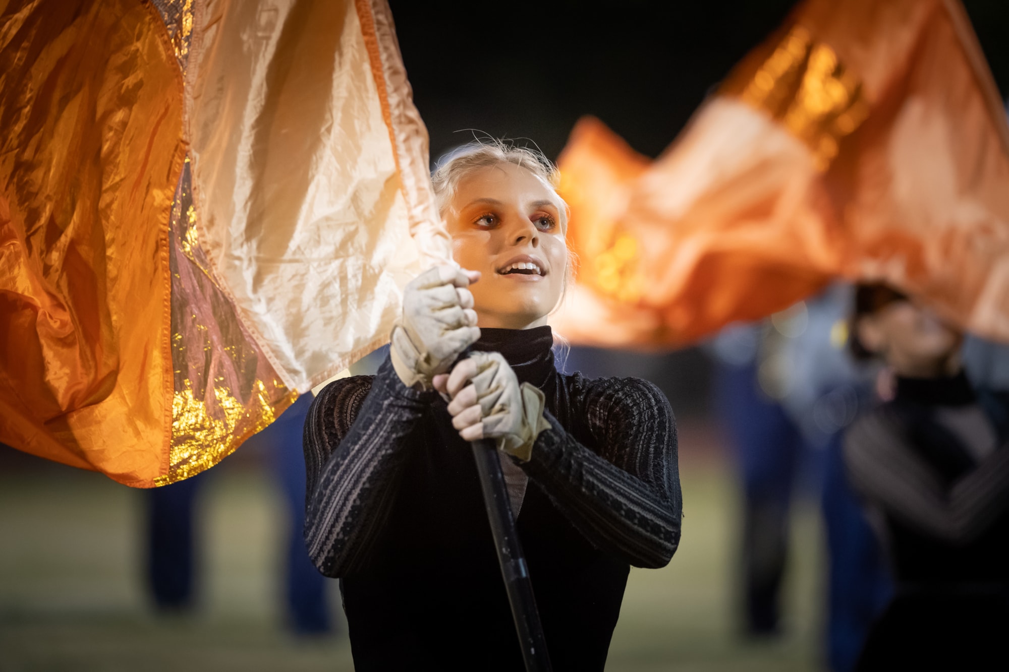 Colorguard student twirling flag.