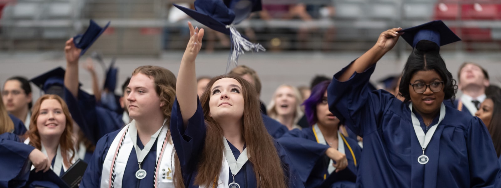 High school graduates throwing their caps in the air