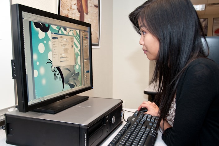 Student designing artwork on a computer