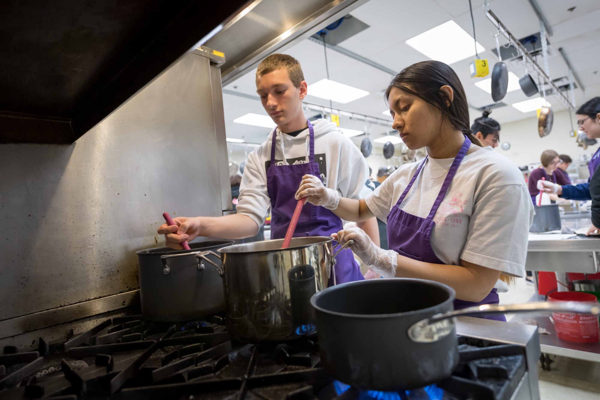 Students cooking on stove