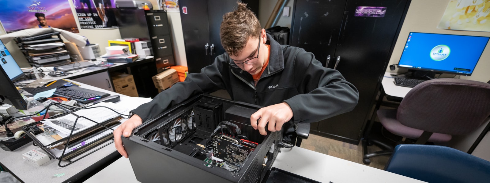 student working on inside of computer.