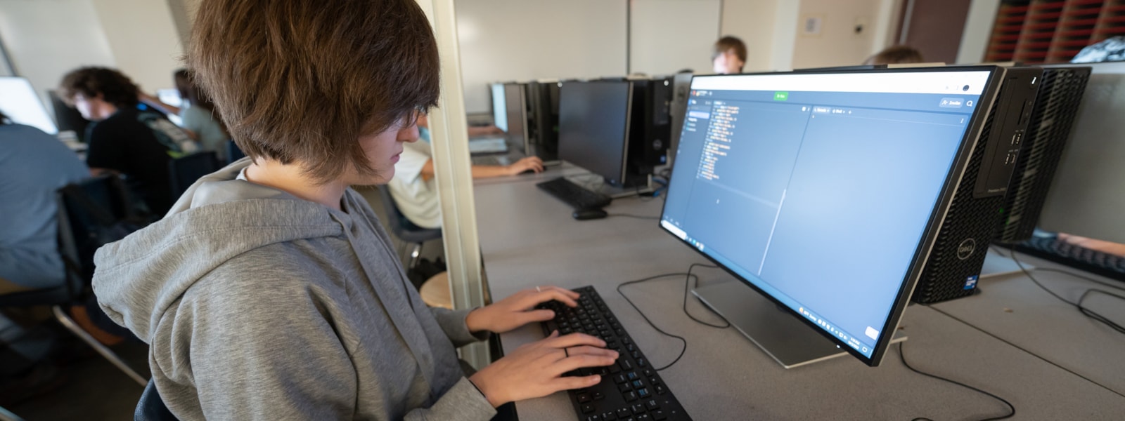 student working on coding on a computer