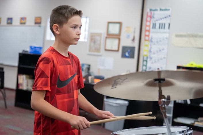 student playing drums