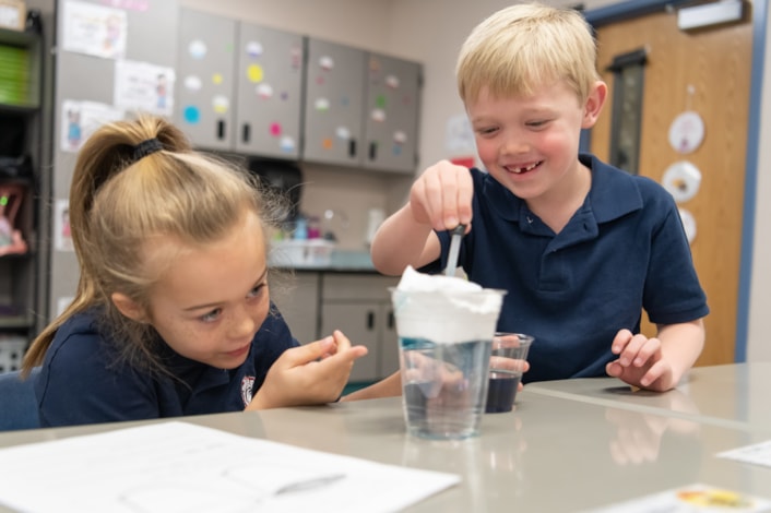 students working on science experiment in classroom