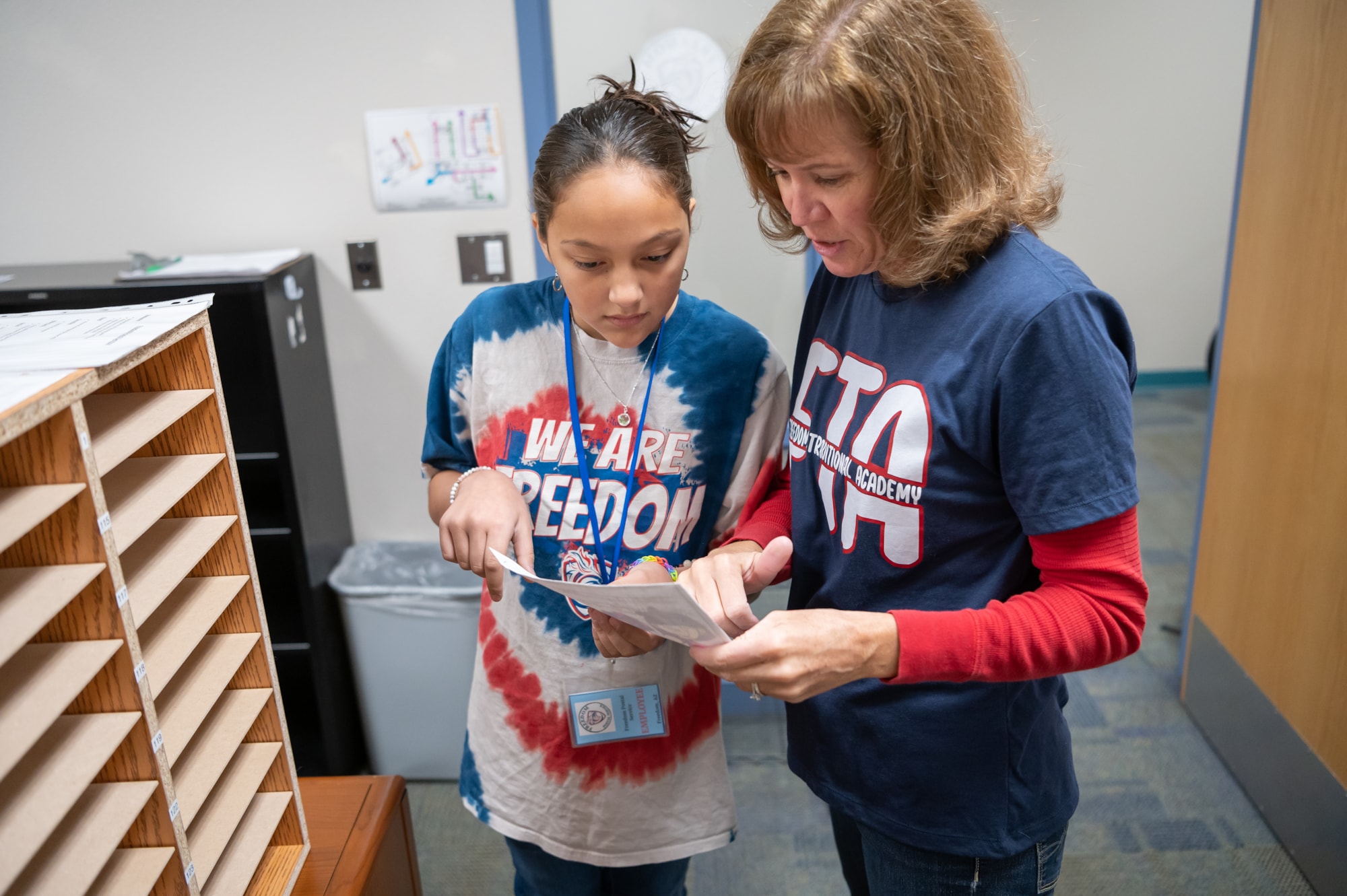 Mrs. Linda Johnson explains to a student the sorting process in the Freedom Traditional Academy Post Office.  Mrs. Johnson started the post office club at the school to help students better learn to write, as well as to educate students on the post office process.