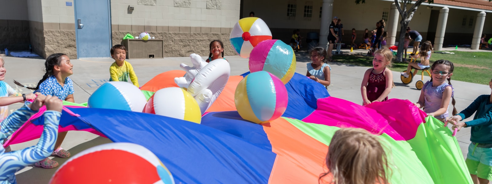 students playing with a parachute and balls