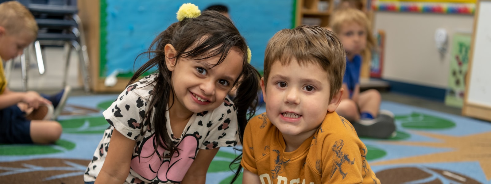 Two preschool students smiling