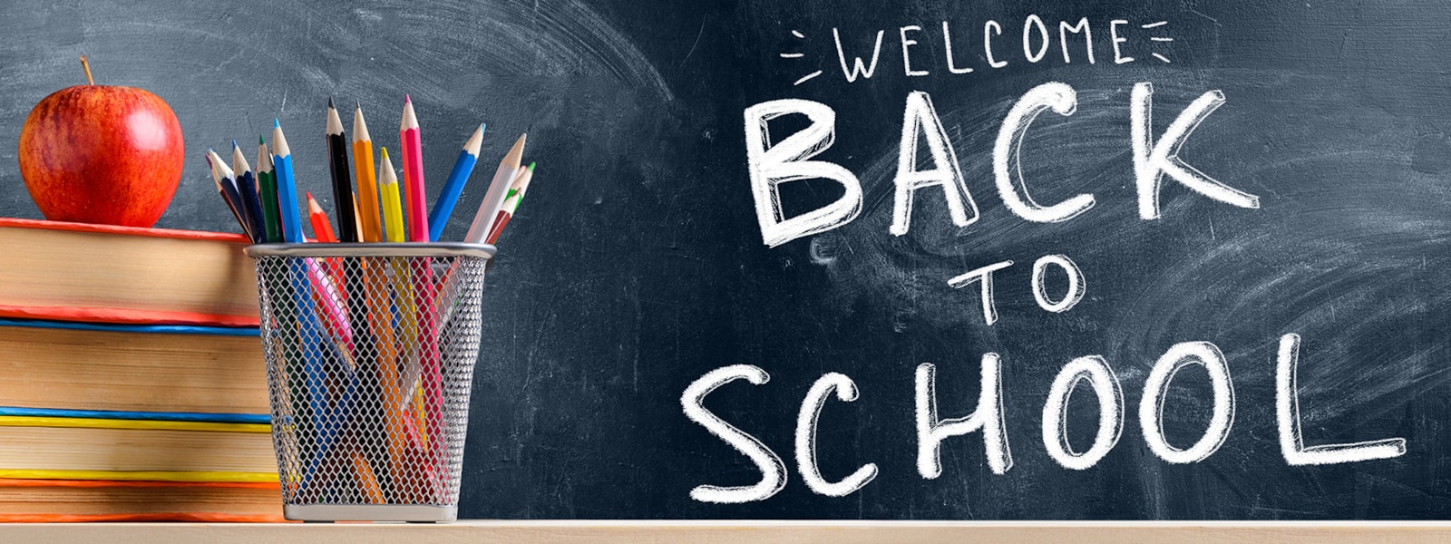 books, pencils, an apple, and a chalkboard that says welcome back to school