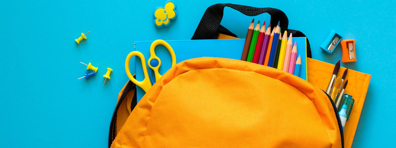 Backpack with pencils, scissors, and other supplies. 