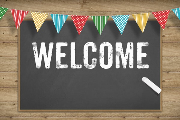 welcome sign with colorful banner above