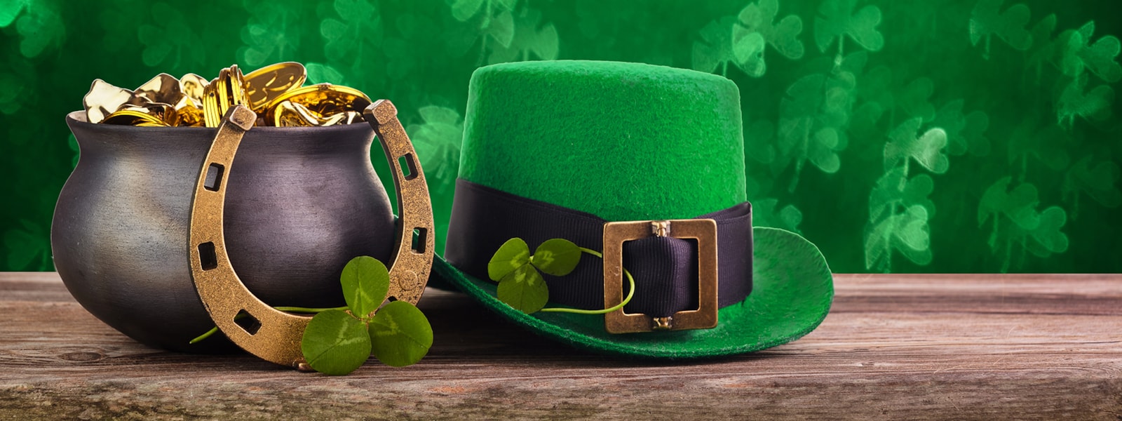 A green hat, pot of gold and horseshoe