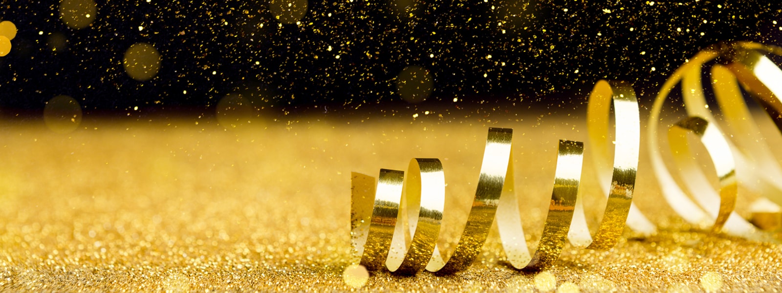 Gold confetti with gold ribbon on black background