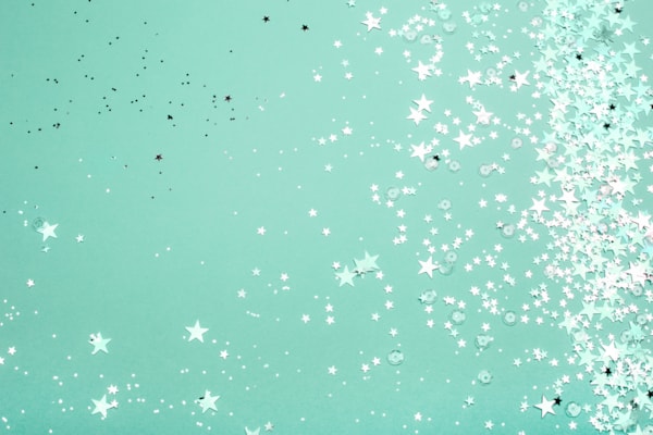 green background with silver star confetti