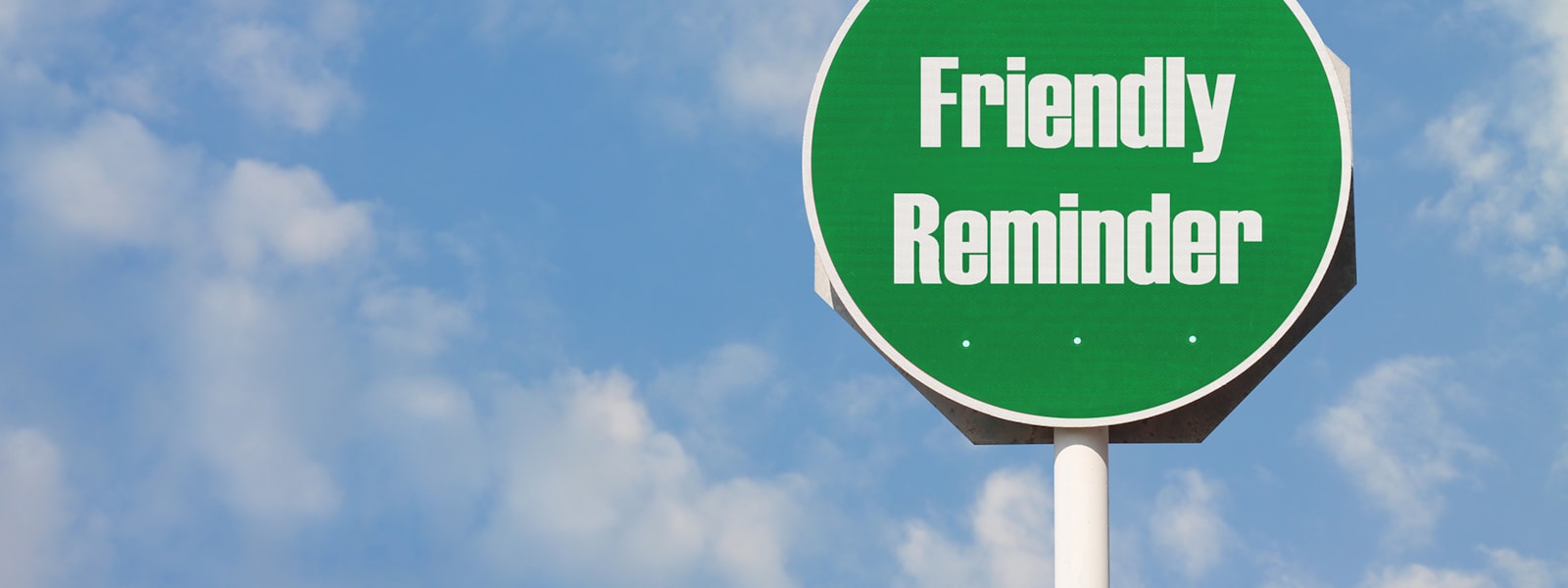 Green Sign stating "Friendly Reminder"