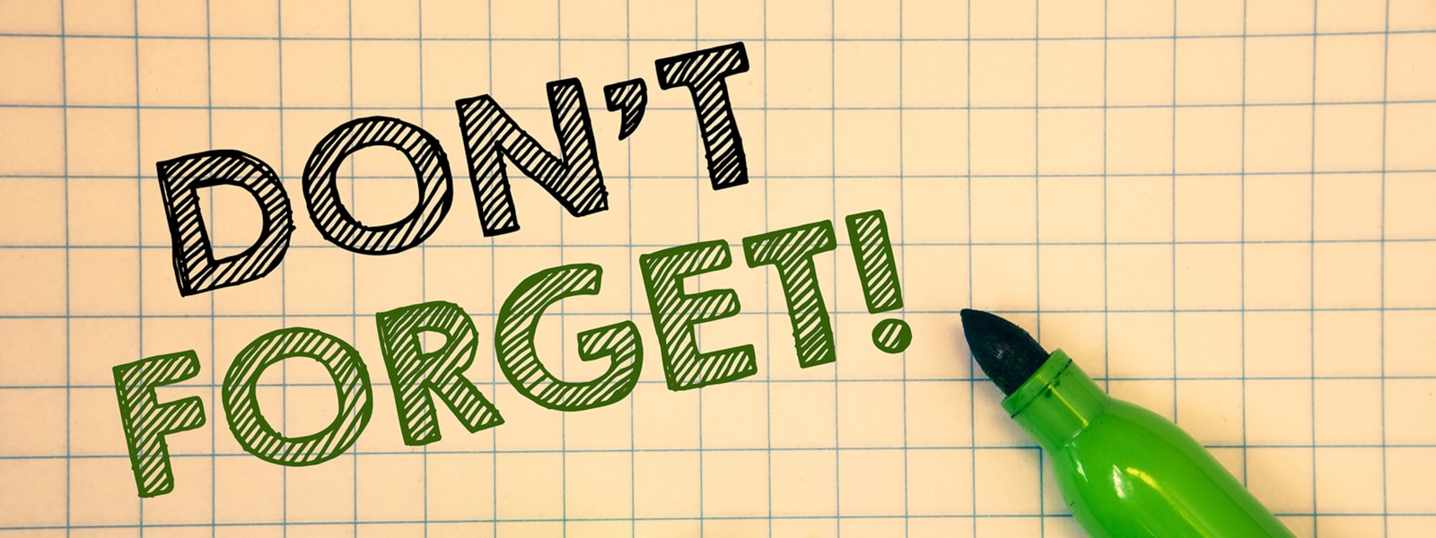 Large Words that say " don't forget" in black and green, in front of Grid paper and a green marker.   