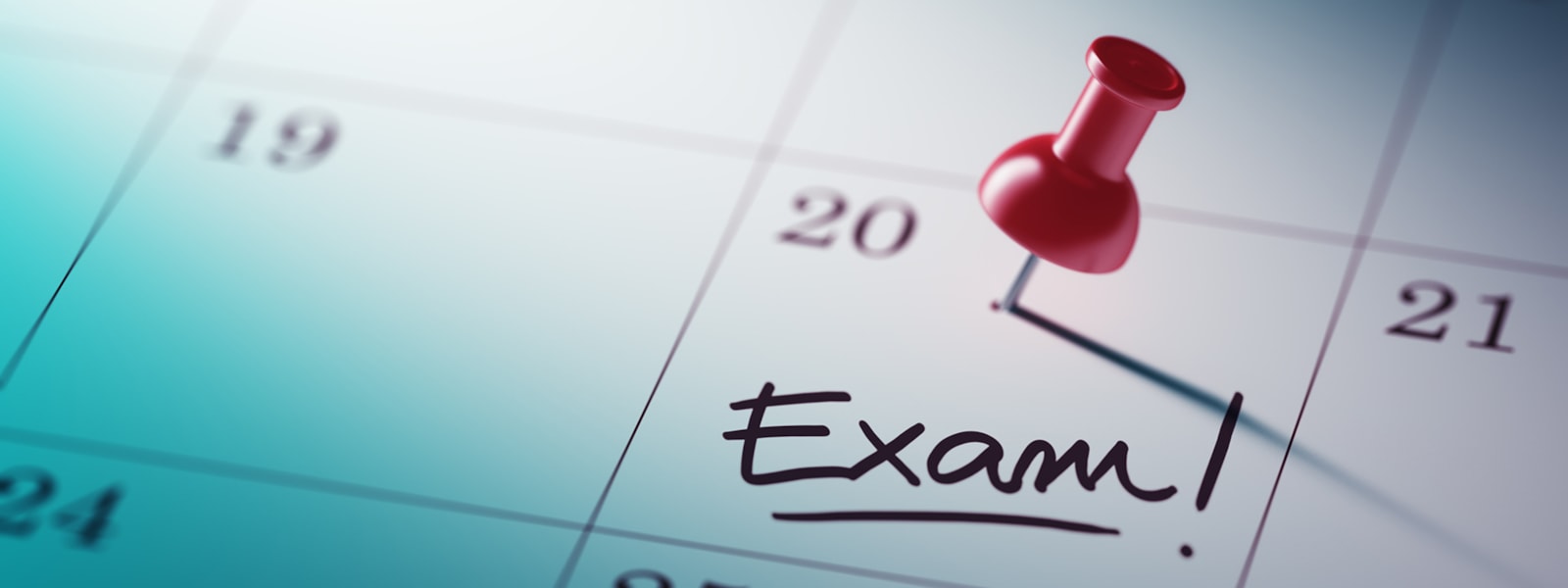 Exam on calendar with a pin
