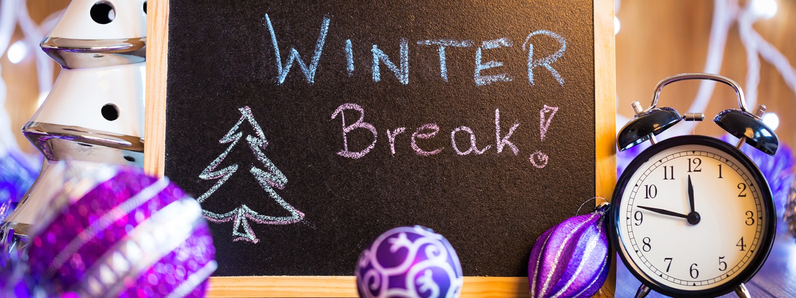 winter break sign with a clock and ornaments