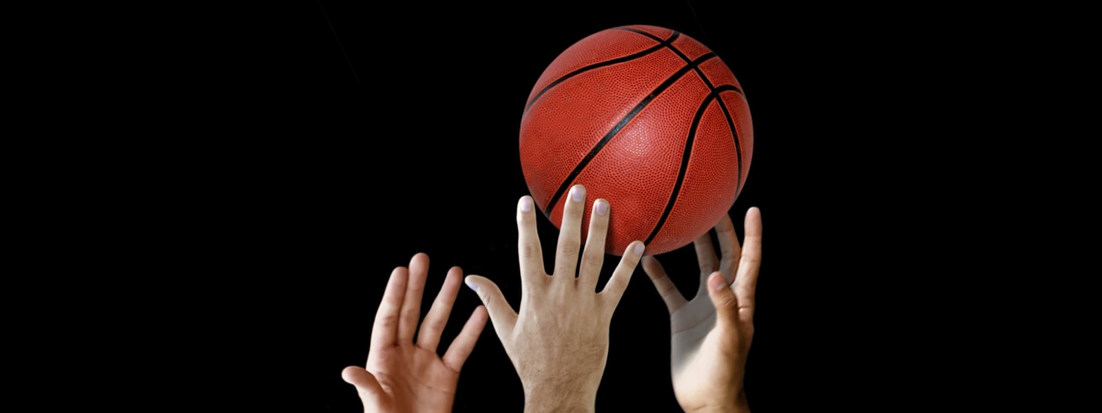 hands grabbing a basketball