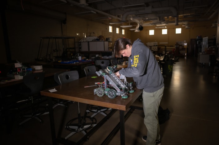 Student working on robot in engineering lab at Shadow Ridge High School.