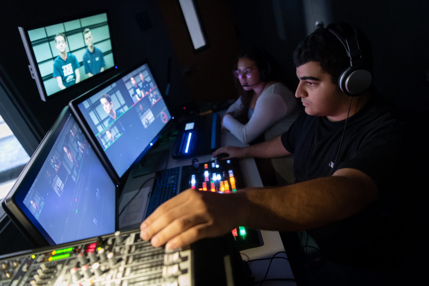 Students working in control booth for tv broadcast