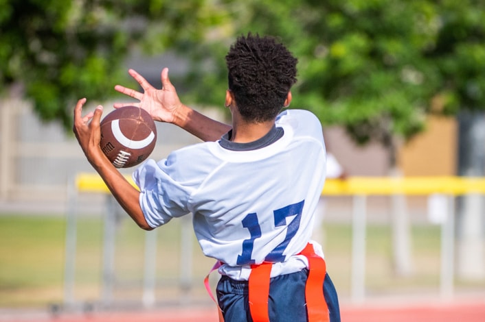 student catching a football