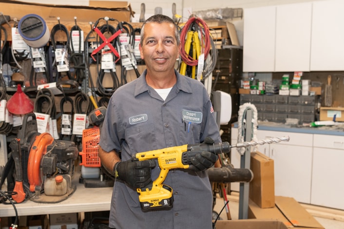 maintenance worker holding drill