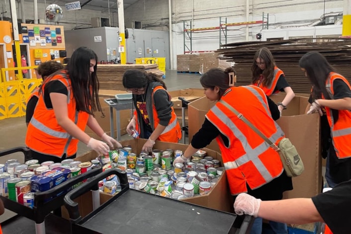 students volunteering at a food bank