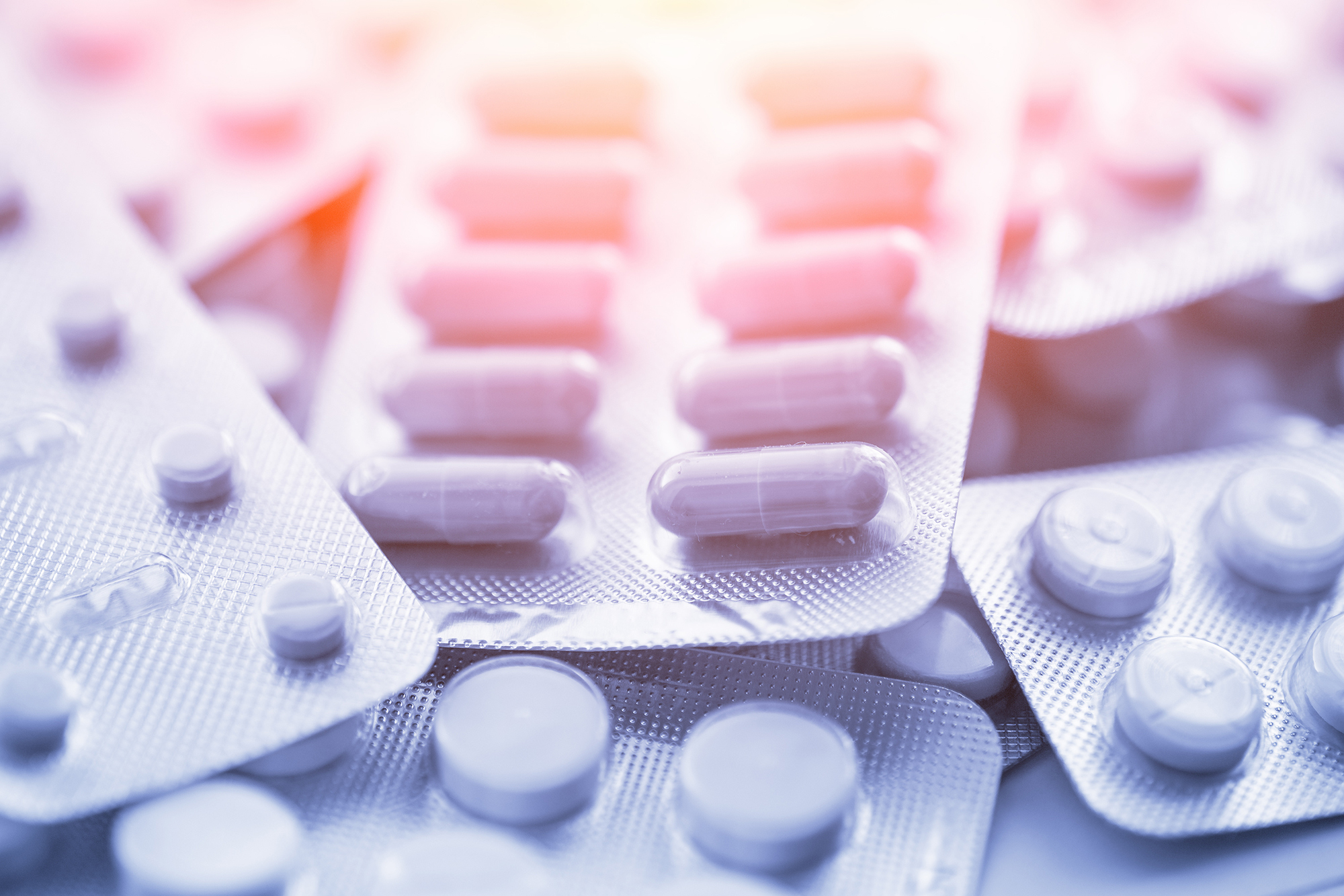 Picture of pills and medications laying on table.