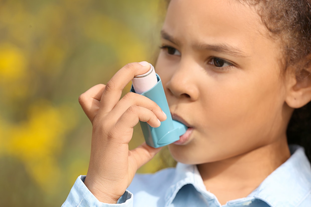 Child using asthma inhaler