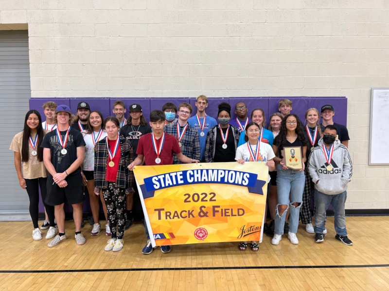 picture of unified track and field team holding up championship banner