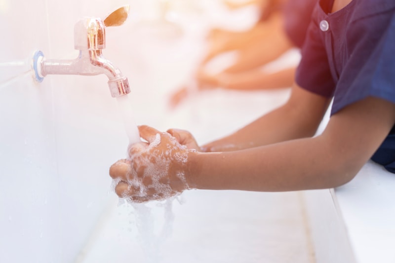 student washing hands