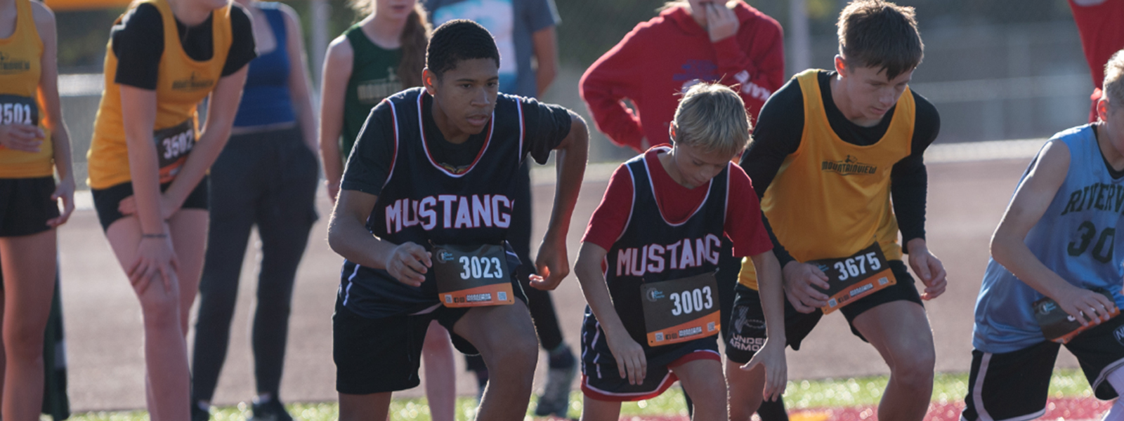 Student running in cross country race.