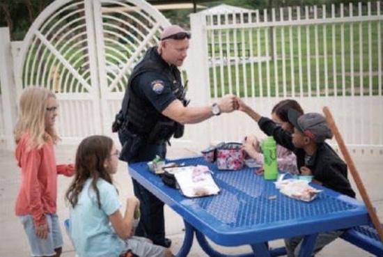 Officer Moore interacting with students at lunch