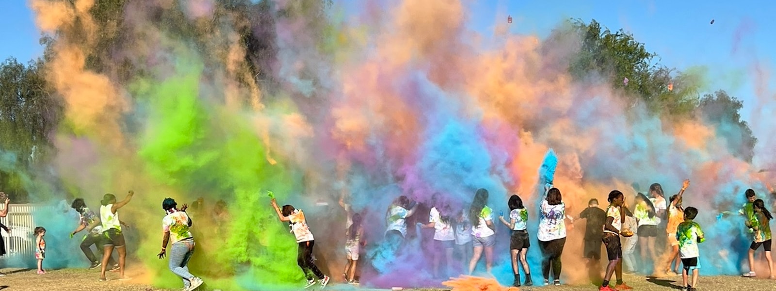 kids throwing colored chalk powder