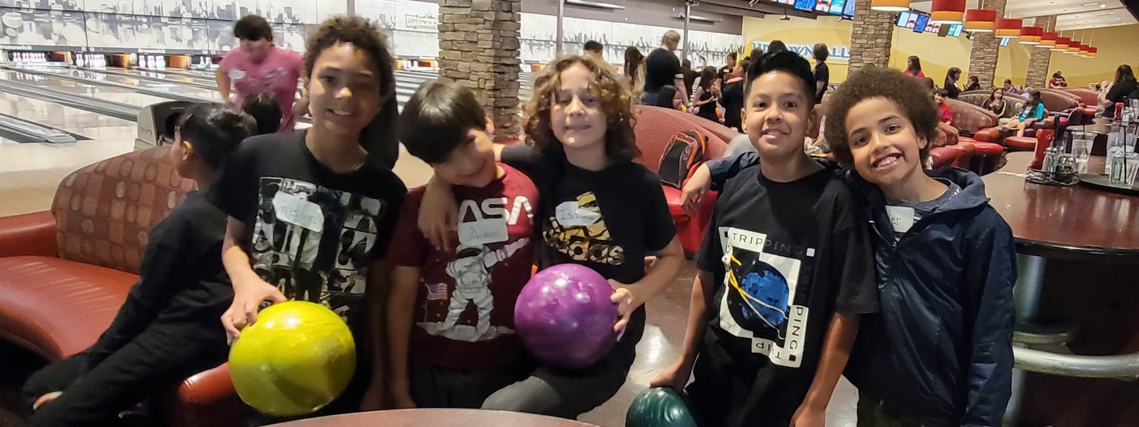 Students at Uptown Alley with bowling balls.