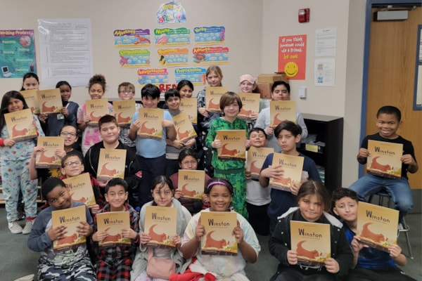 4th grade class holding books