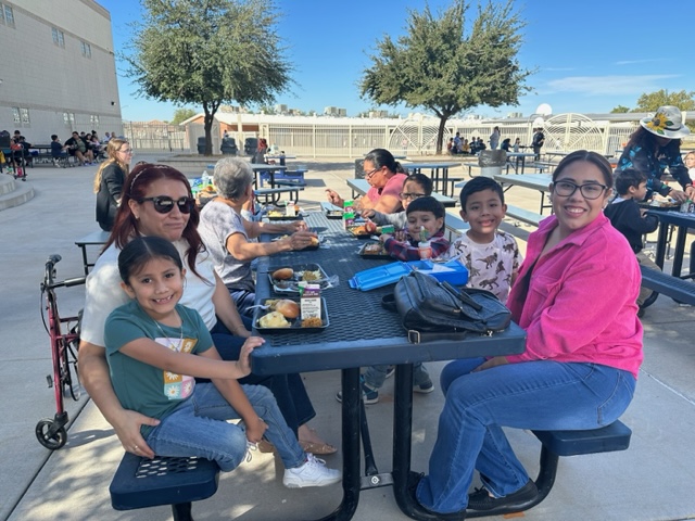 Families enjoying Thanksgiving lunch.