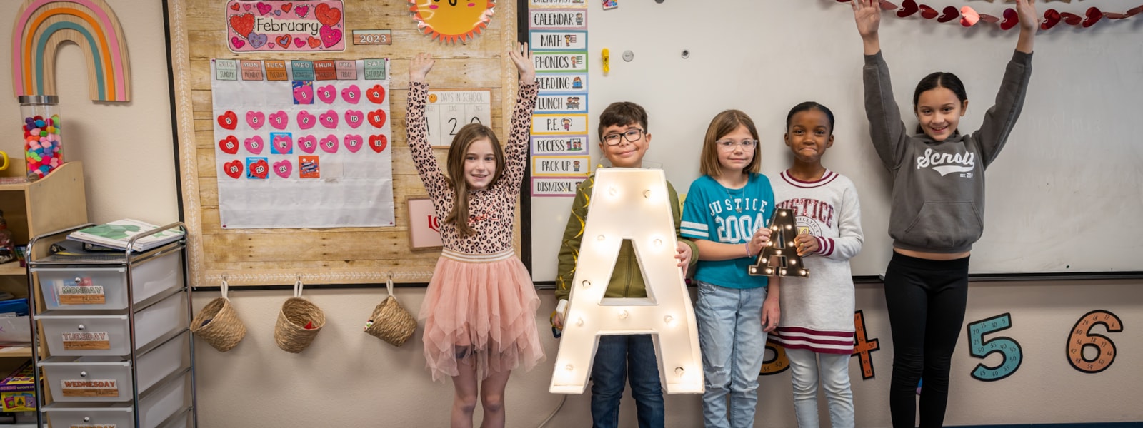 Students holding "A" to celebrate 