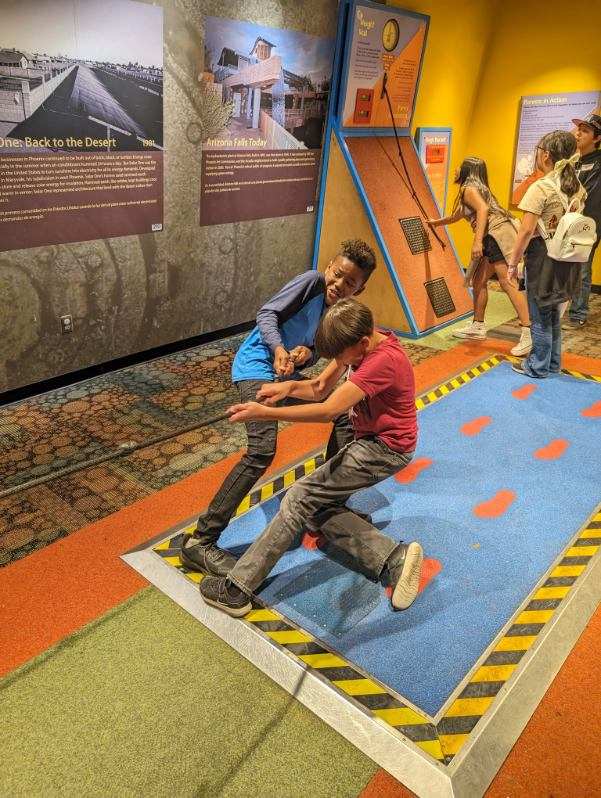 Two students pulling a rope at the Arizona Science Center