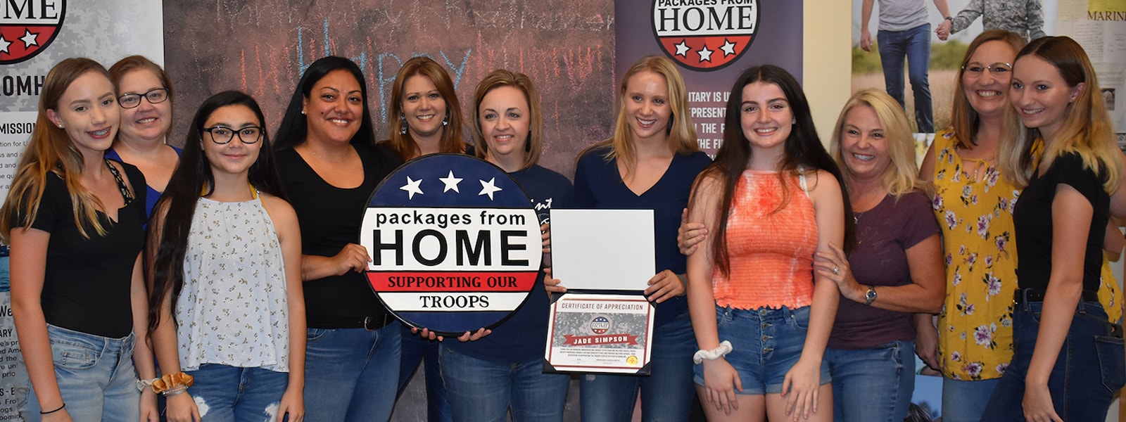 students and teachers who participated in packages from home pose for a picture.