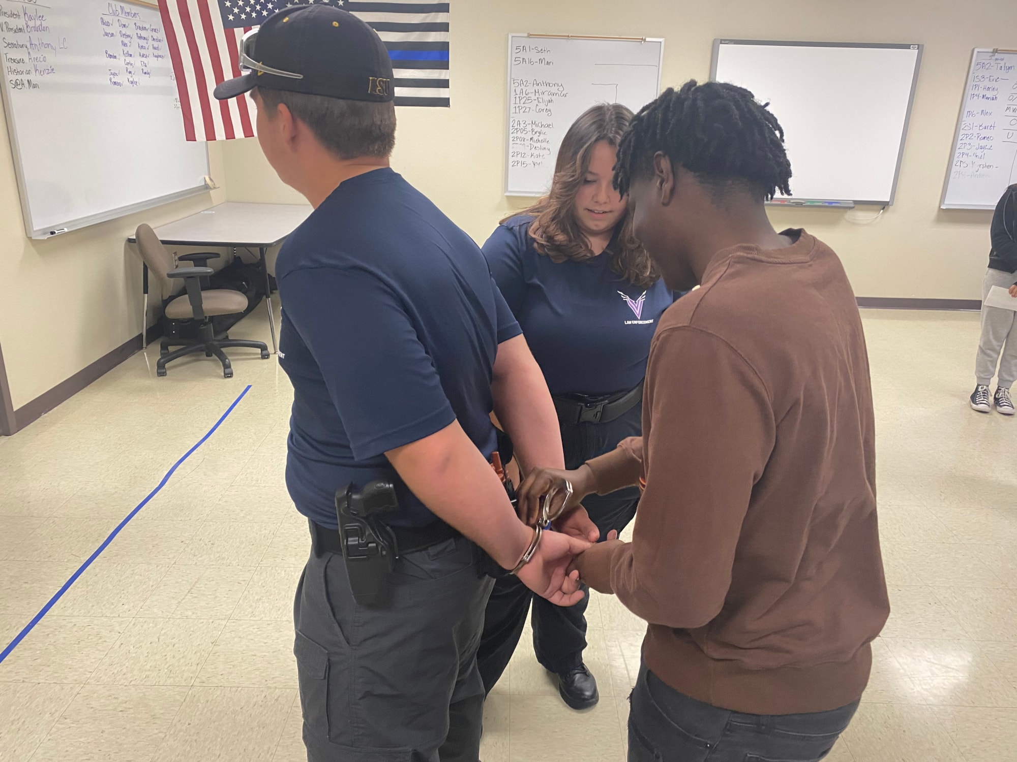 Student pretends to handcuff a suspect